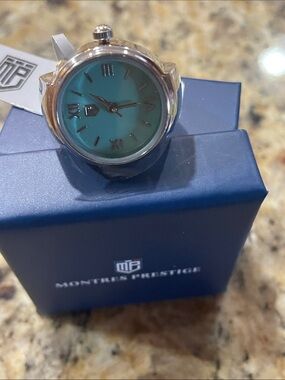 Montres Prestige Silver Ring Watch with Teal Dial